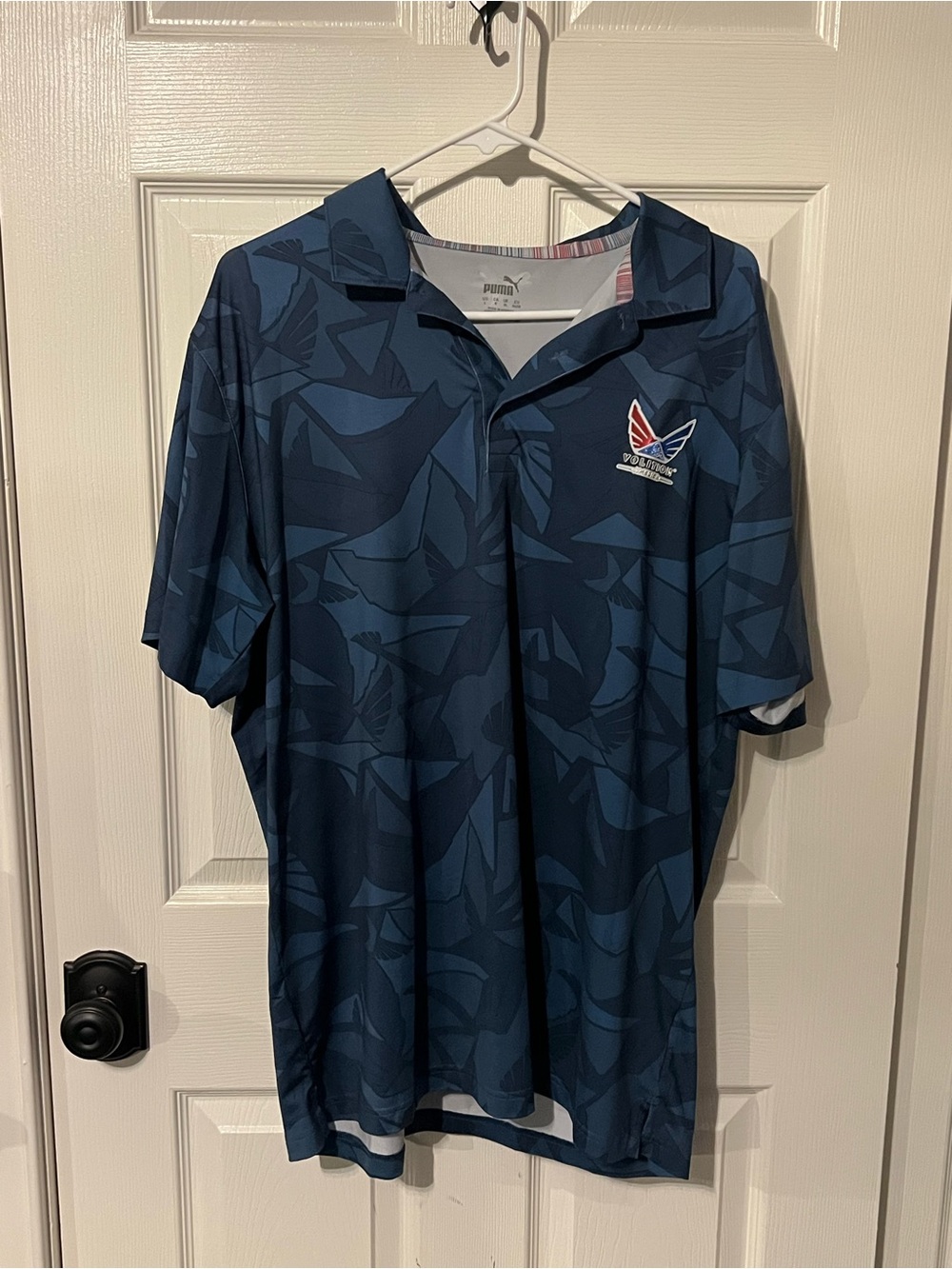 Puma Men’s Dark Blue Graphic Golf Polo with Red & White Logo Volition America